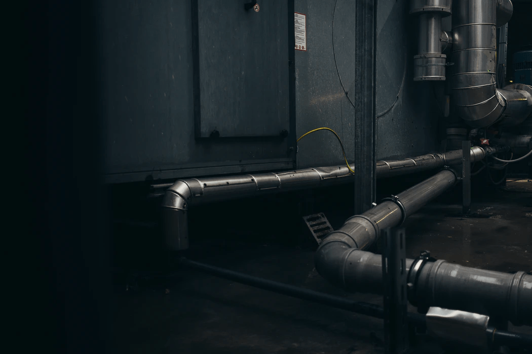 gray plumbing pipes mounted on wall