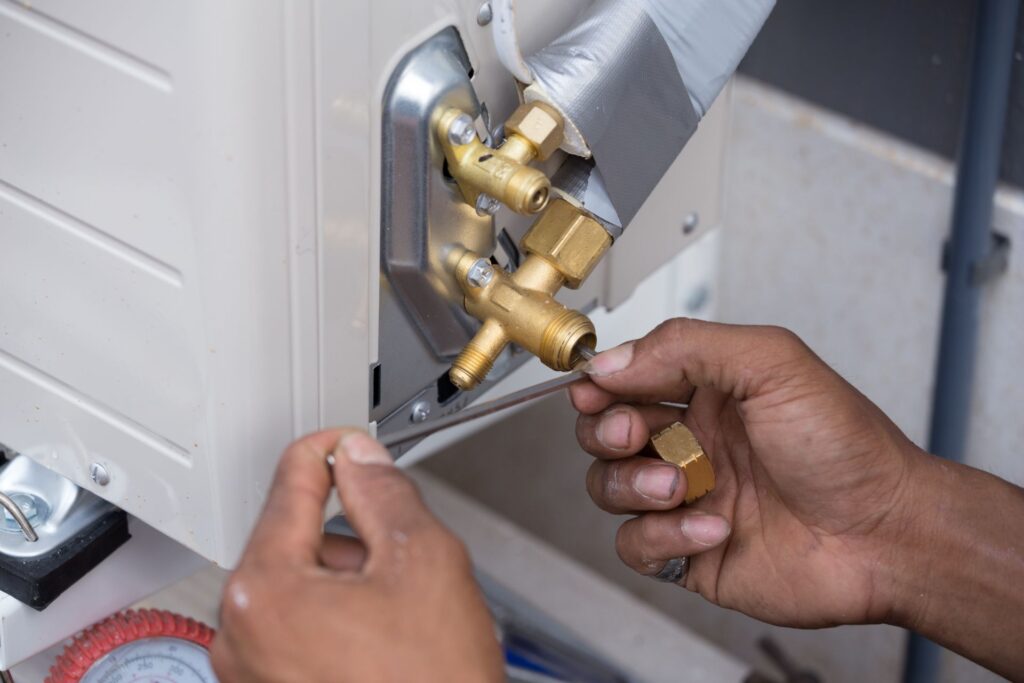 Installation of air conditioner, worker open drip valve
