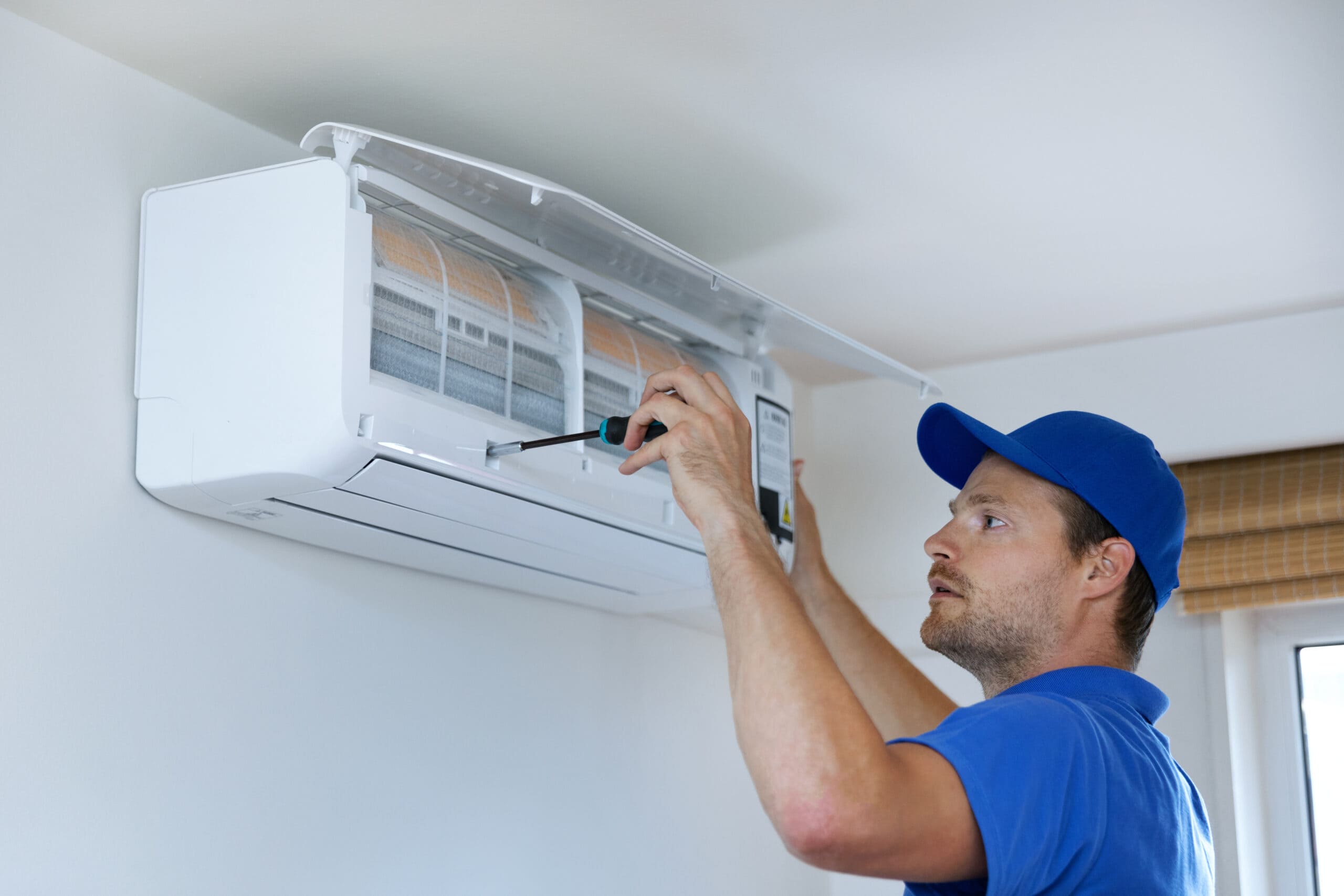 air conditioning technician repairing unit