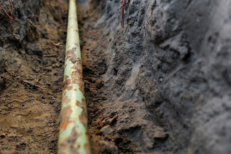 Detail of a residential water pipe in a trench.